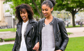 zwei Frauen nebeneinander laufend im Park